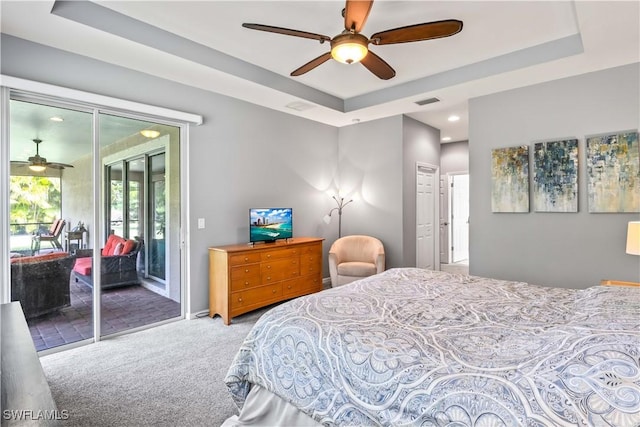 carpeted bedroom with access to outside, ceiling fan, and a tray ceiling