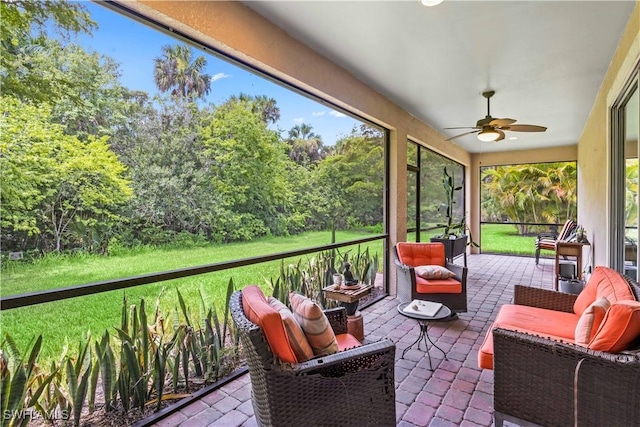 sunroom / solarium featuring ceiling fan