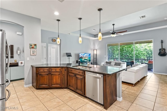 kitchen featuring light tile patterned flooring, sink, hanging light fixtures, appliances with stainless steel finishes, and ceiling fan