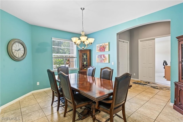 dining space featuring light tile patterned floors and a chandelier