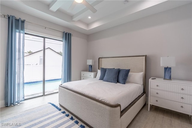 bedroom with access to exterior, beam ceiling, multiple windows, and light wood-type flooring