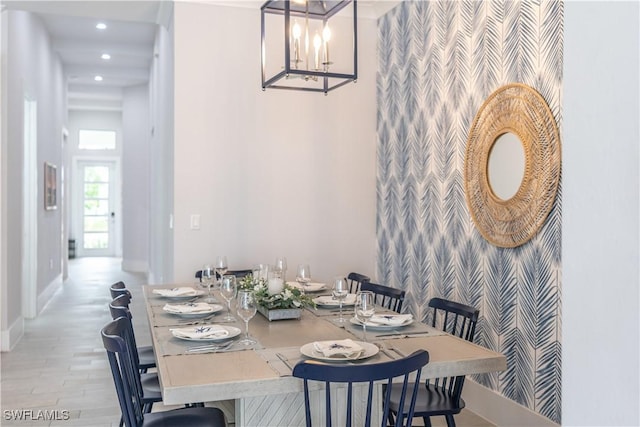 dining area with a towering ceiling and light hardwood / wood-style flooring