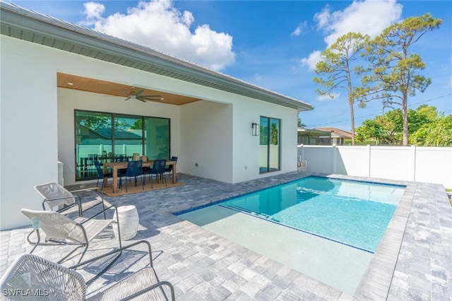 view of swimming pool featuring a patio and ceiling fan