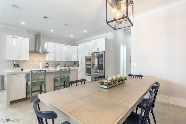 dining area featuring sink and ornamental molding