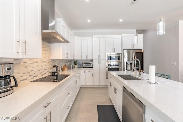 kitchen featuring wall chimney exhaust hood, stainless steel appliances, sink, and white cabinets