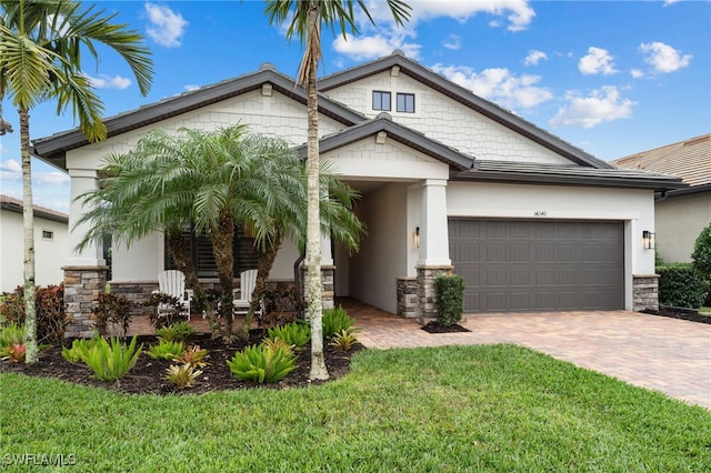 view of front of property featuring a garage and a front lawn