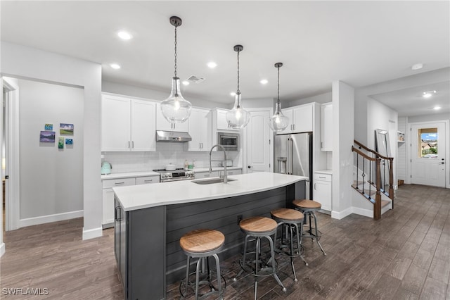 kitchen with white cabinetry, sink, an island with sink, and appliances with stainless steel finishes