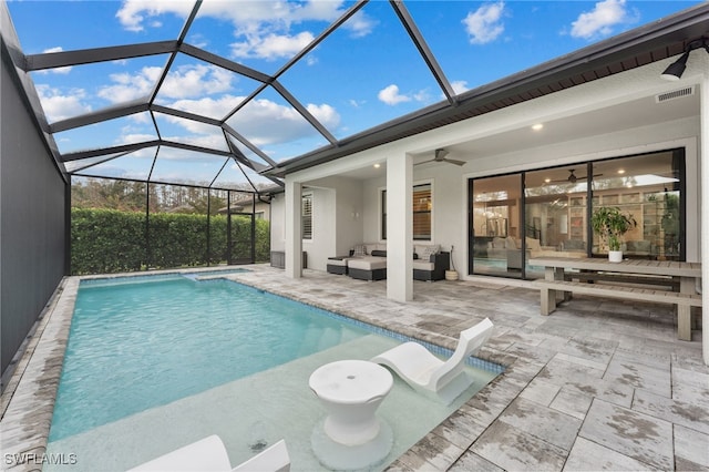 view of pool with outdoor lounge area, ceiling fan, a lanai, and a patio