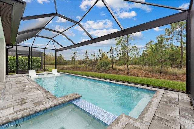 view of pool featuring a patio and glass enclosure