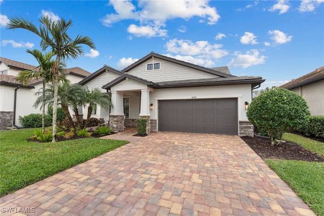 view of front of property featuring a garage and a front yard