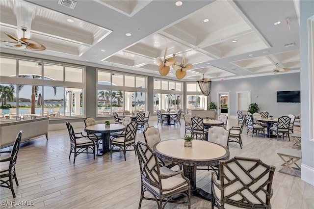 dining space with coffered ceiling, ceiling fan, light hardwood / wood-style flooring, and beamed ceiling