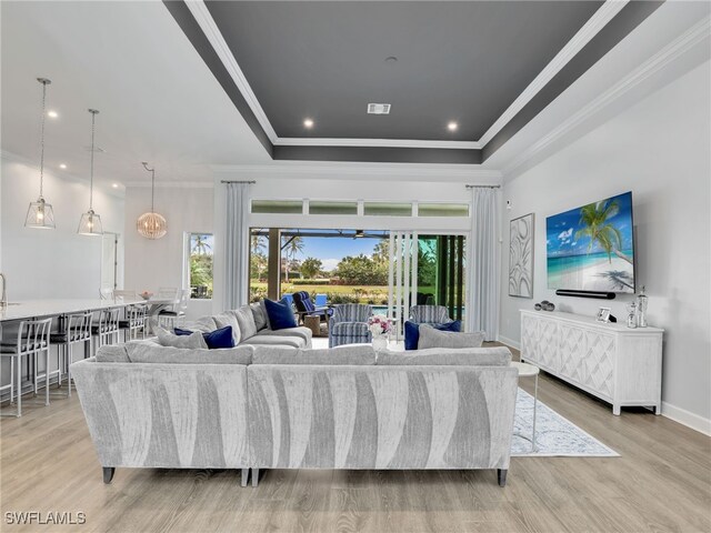 15583 Montello Ln, Naples, FL 34114 - living area featuring crown molding, recessed lighting, a raised ceiling, and light wood finished floors