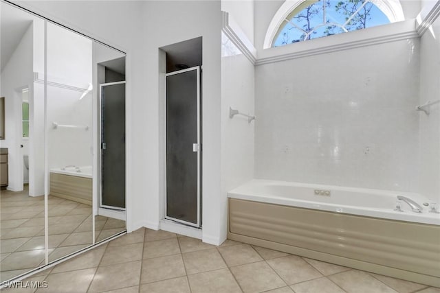 bathroom featuring independent shower and bath and tile patterned flooring