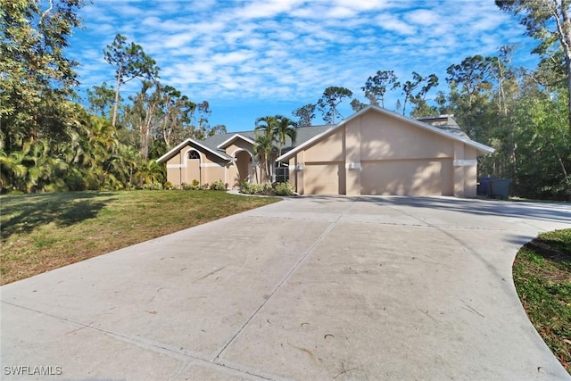 single story home with a garage and a front yard