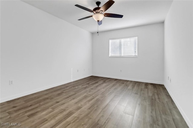 unfurnished room with hardwood / wood-style flooring and ceiling fan