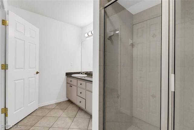 bathroom featuring tile patterned floors, vanity, and a shower with shower door