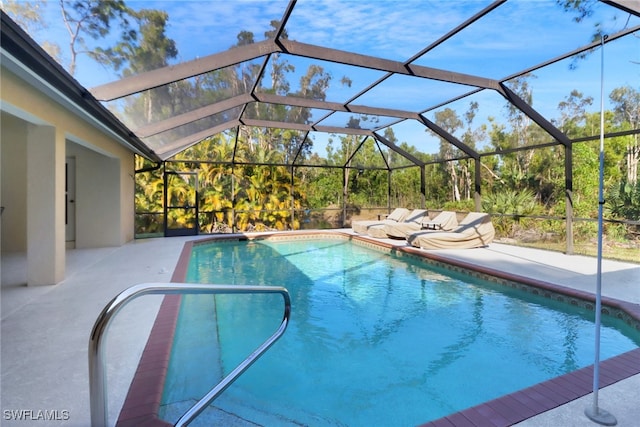 view of swimming pool with a patio area and glass enclosure