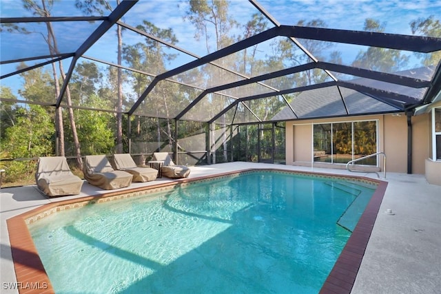 view of swimming pool featuring a lanai and a patio area