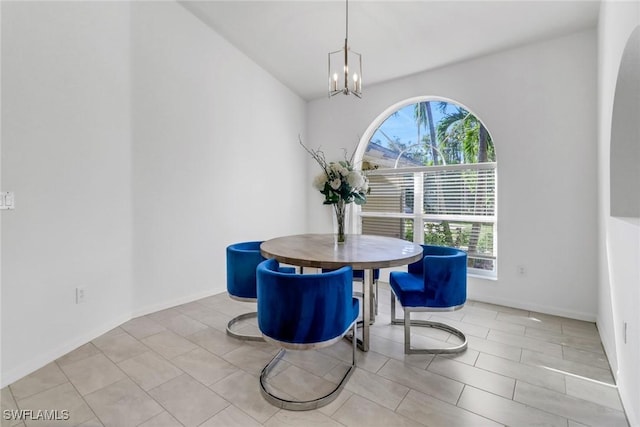 dining area with a chandelier and light tile patterned floors