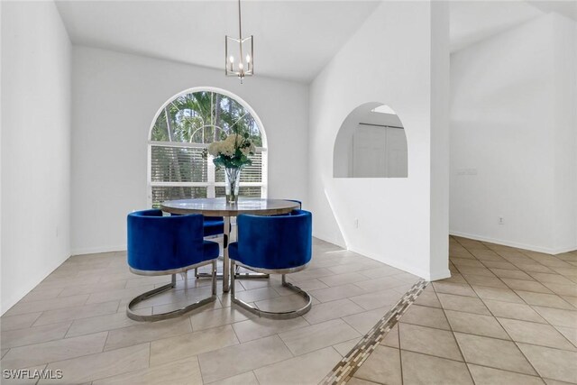 tiled dining space featuring an inviting chandelier