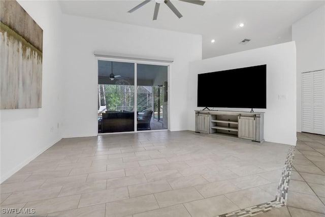 unfurnished living room with ceiling fan and light tile patterned floors