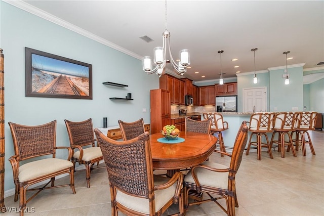 dining room with crown molding, light tile patterned floors, and a chandelier