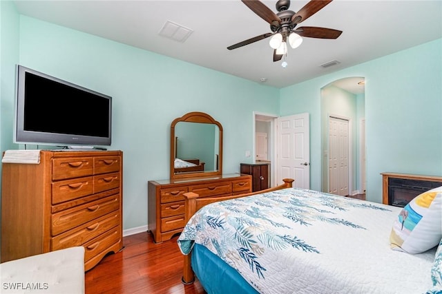 bedroom with ceiling fan, dark hardwood / wood-style floors, and a closet