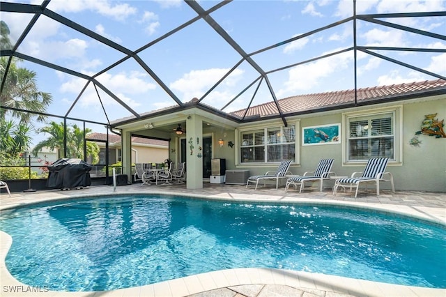 view of swimming pool with ceiling fan, grilling area, a lanai, and a patio area