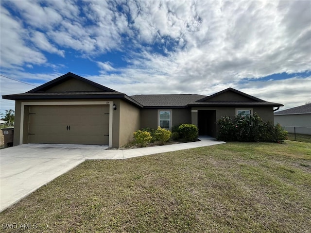 ranch-style home featuring a garage and a front lawn