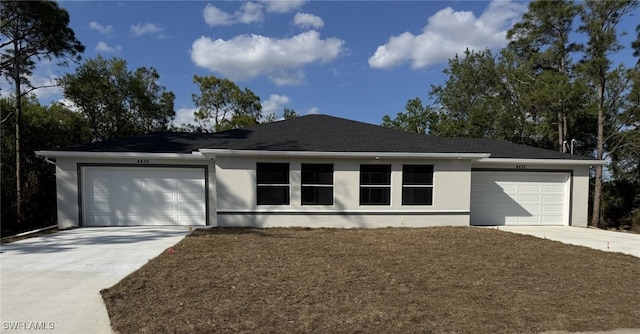 ranch-style home featuring stucco siding, driveway, and a garage