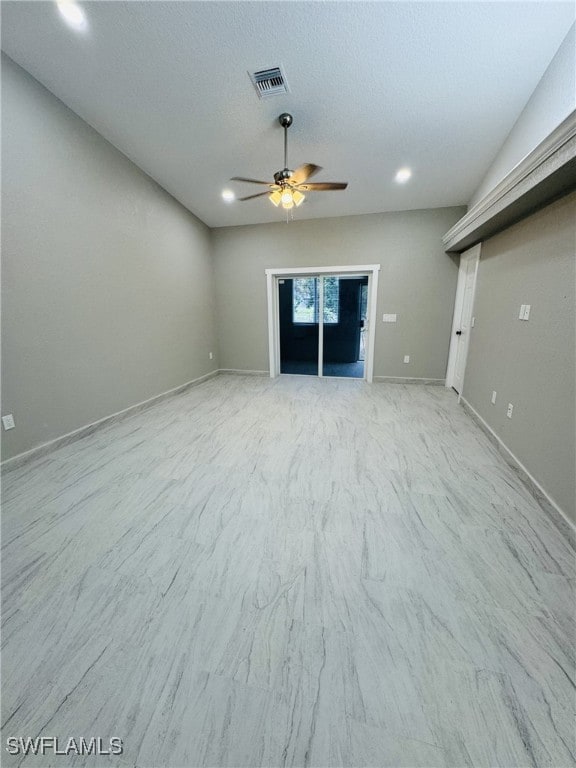 unfurnished living room featuring baseboards, visible vents, a textured ceiling, and a ceiling fan