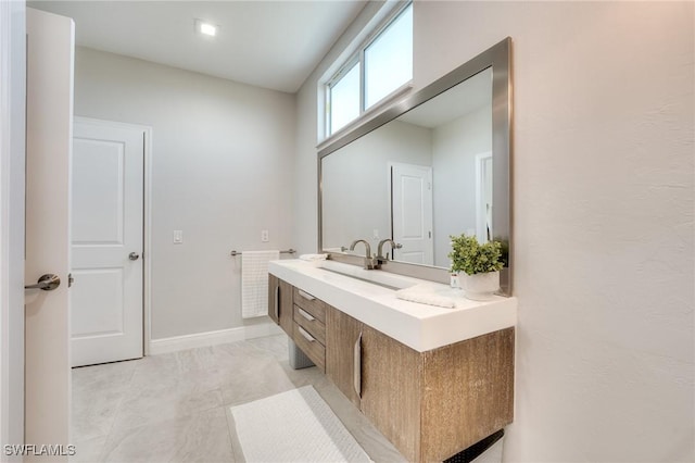 bathroom featuring baseboards and vanity