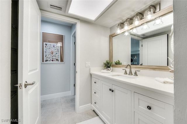 bathroom with tile patterned floors, vanity, visible vents, and baseboards