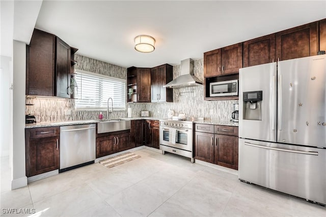 kitchen with stainless steel appliances, dark brown cabinets, wall chimney range hood, open shelves, and a sink