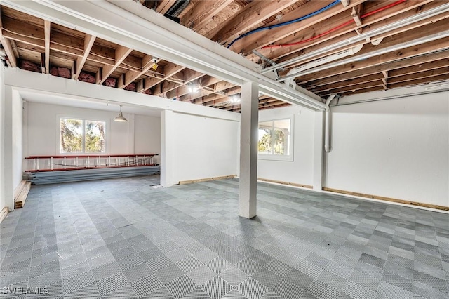 below grade area with a healthy amount of sunlight and tile patterned floors