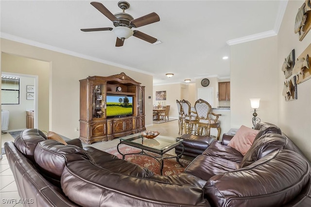 tiled living room with crown molding and ceiling fan