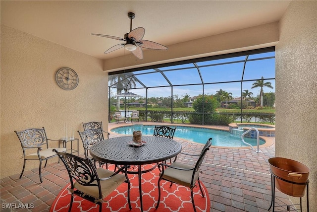 view of swimming pool with an in ground hot tub, a water view, a patio area, and glass enclosure