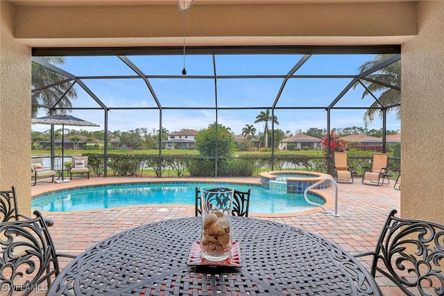 view of swimming pool featuring a lanai, a patio area, and an in ground hot tub