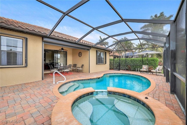 view of pool featuring an in ground hot tub, a lanai, and a patio