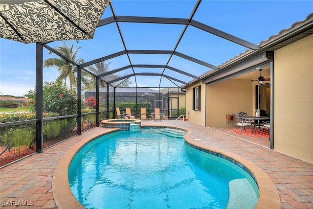 view of swimming pool featuring an in ground hot tub, glass enclosure, and a patio