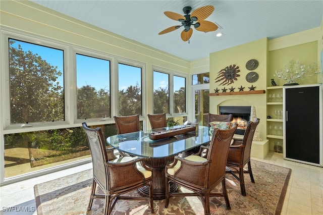 sunroom featuring ceiling fan and a wealth of natural light