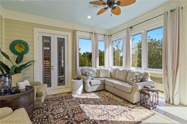 sunroom / solarium featuring plenty of natural light, ceiling fan, and french doors