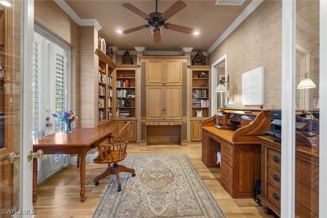 office area with crown molding, built in desk, and light hardwood / wood-style flooring