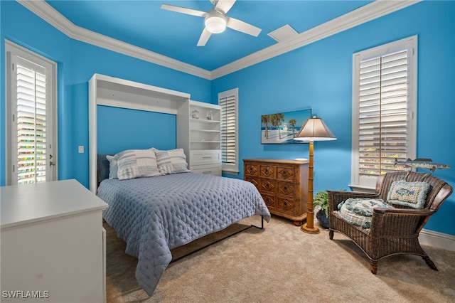 carpeted bedroom with ornamental molding and ceiling fan