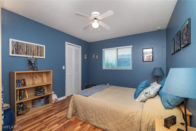 bedroom featuring hardwood / wood-style floors, a closet, and ceiling fan