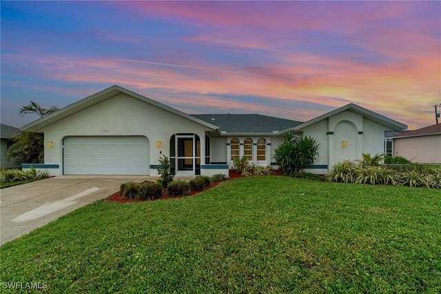 single story home with a garage and a lawn