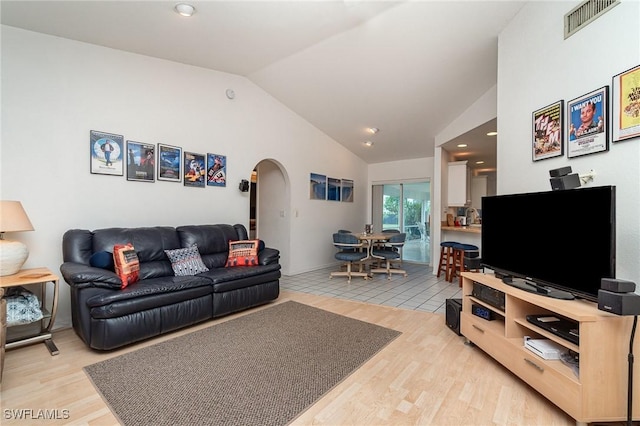 living room with lofted ceiling and light hardwood / wood-style floors