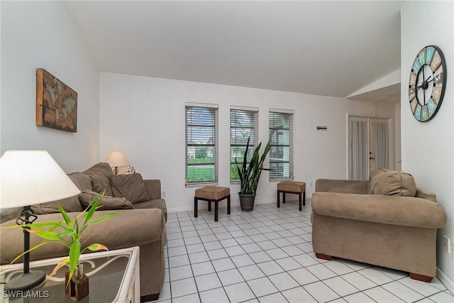 living room with vaulted ceiling and light tile patterned flooring