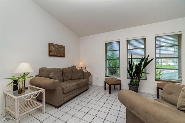 tiled living room featuring vaulted ceiling