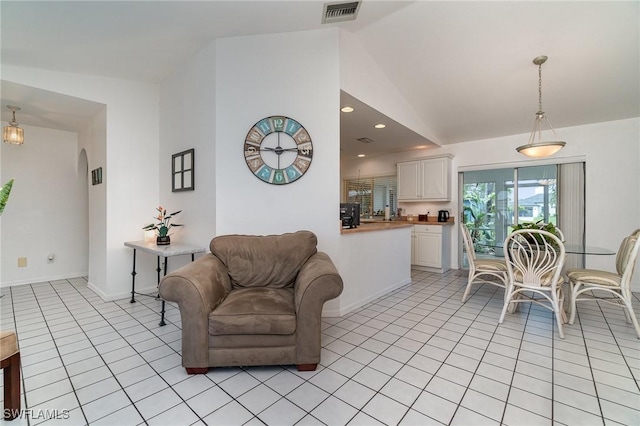 tiled living room featuring vaulted ceiling